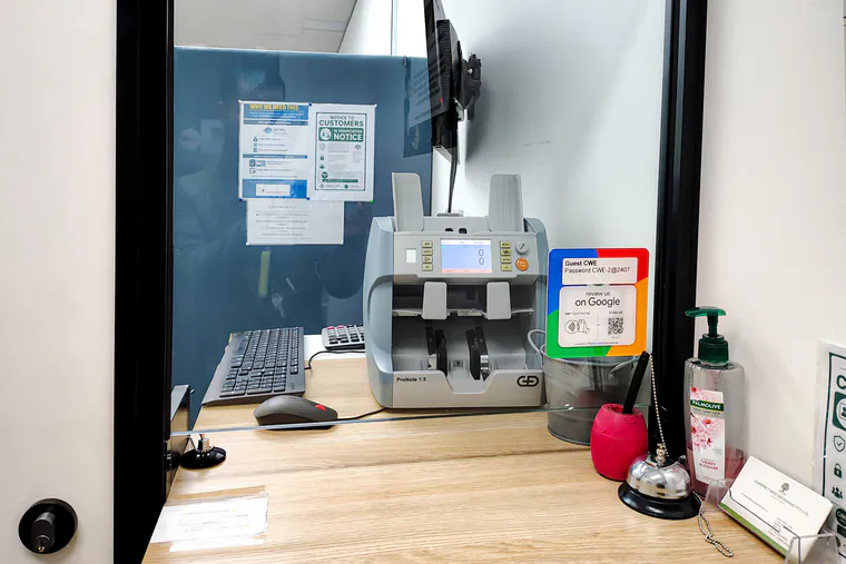 The Currency Wise Exchange counter at Suite 202A, with the note-counting machine and screen used to check and count cash.