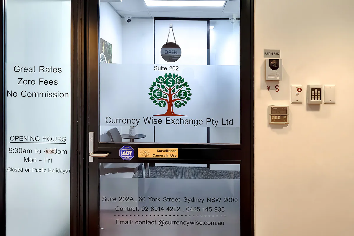 The glass entrance door to Currency Wise Exchange at Suite 202A, 60 York Street, Sydney NSW 2000, with the intercom and door keypad on the wall beside it.